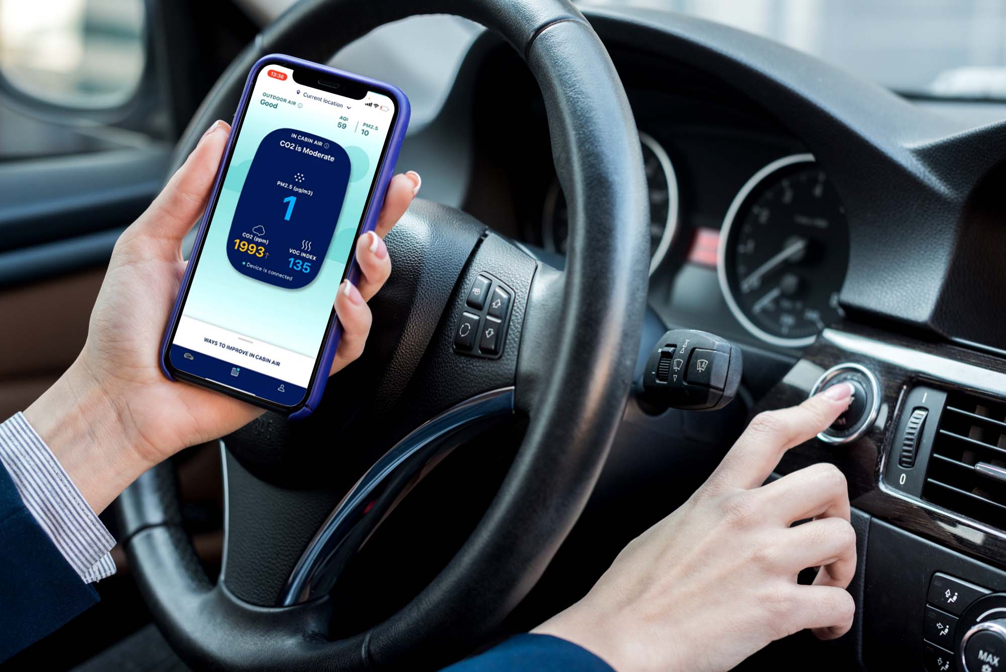 A person inside a car checking air quality through an app 